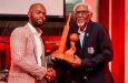 CWI president Dr Kishore Shallow presenting Conde Riley with an award in 2024