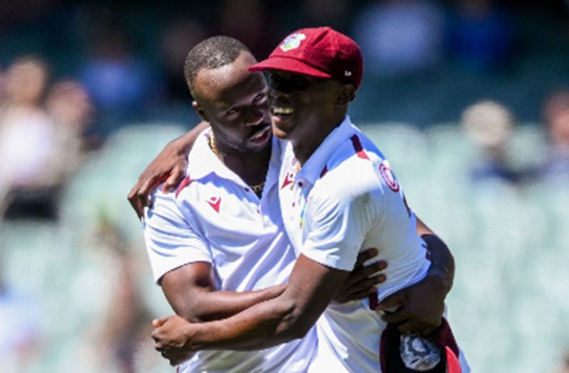 Fast bowler Shamar Joseph (right) celebrates with Kemar Roach on the recent tour of Australia.