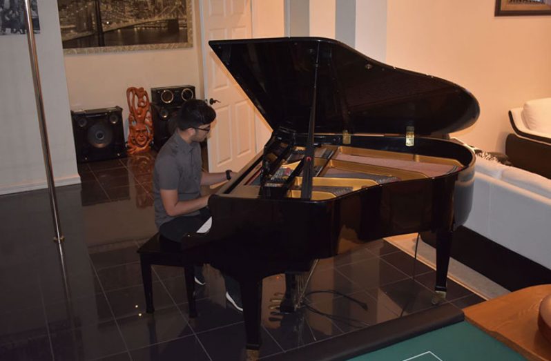 Shane playing a tune on a grand piano