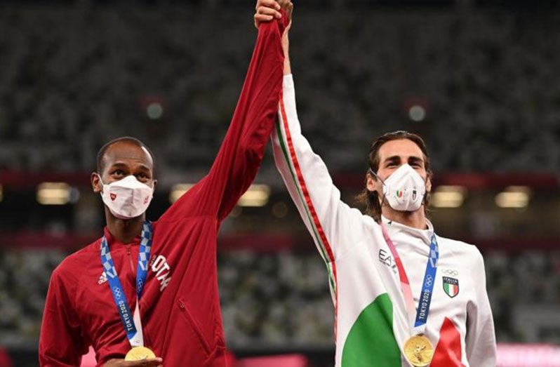 Mutaz Essa Barshim of Qatar and Gianmarco Tamberi of Italy agree to share gold instead of going into a jump-off during the men's high jump.