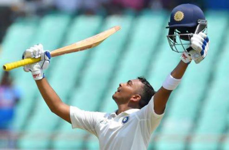 India's Prithvi Shaw celebrates after scoring a century during the first Test cricket match against the West Indies at the Saurashtra Cricket Association stadium in Rajkot in this October 4, 2018 file photo. (AFP)