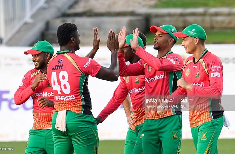 Brandon King (2R), Chris Green (R) and Romario Shepherd (2L) of Guyana Amazon Warriors celebrate the dismissal of Rashid Khan of Barbados Tridents during the Hero Caribbean Premier League match 26 between Barbados Tridents and Guyana Amazon Warriors at Brian Lara Cricket Academy on September 3, 2020 in Tarouba, Trinidad And Tobago. (Photo by Randy Brooks - CPL T20/CPL T20 via Getty Images)