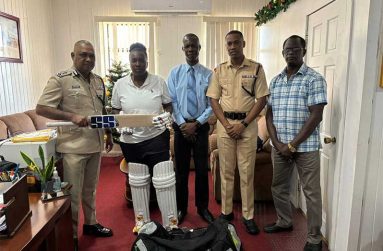 L-R Deputy Commissioner “Administration” Mr Ravindradat Budhram, Chairman of the Police Officers’ Cricket Team, hands over the gear to Lance Corporal Sherica Campbell
In the photo are Senior Superintendent Jermaine Johnson, Officer-in-Charge of Information Technology and Communication; Superintendent Ronald Alli, Second-in-Command of the Tactical Services Unit and Vice-Captain of the Officers’ Cricket Team and Sports Development Officer, Colin Boyce.