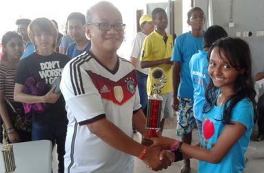 Sheriffa Ali collects her first place trophy after she won the level three (Bishop) category in the Loper Klasse Open Rapid 2014 competition in Suriname last Sunday.