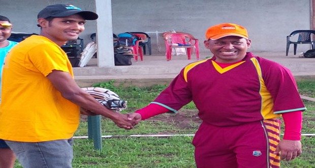 Proprietor of Tiger Sports and former national wicketkeeper/batsman, Sheik Mohamed (right), presents a pair of batting gloves to Guyana Media XI opener Ravi Persaud.