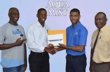 Youth cricketer Shimron Hetmyer (second left) receives his sponsorship package from Errol Nelson, Banks DIH Limited Brand Manager (Water) while his father Gladston Hetmyer (left) and Banks DIH’s Communications Manager Troy Peters look on.