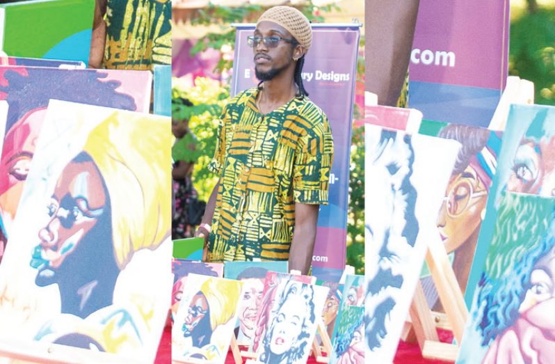 Artist Shimuel Jones (centre) with some of his art