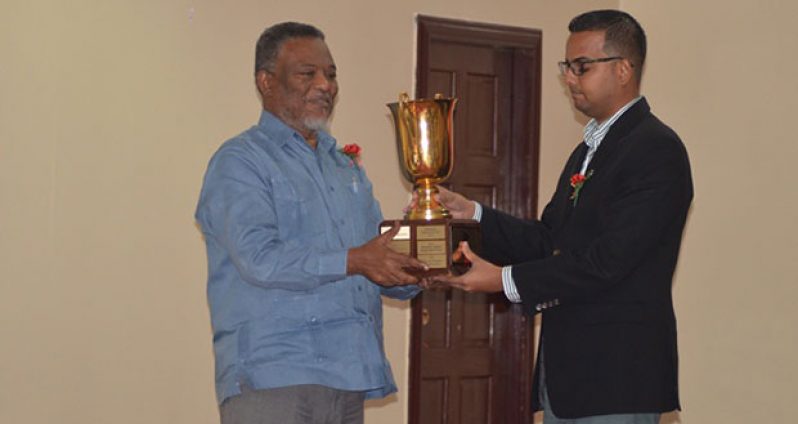Prime Minister Samuel Hinds presents the President’s Award to Superior Shingles Wood Products’ representative, George Bulkan