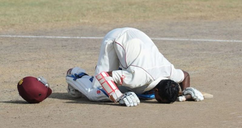 Shivnarine Chanderpaul kisses the pitch as he celebrates his century.