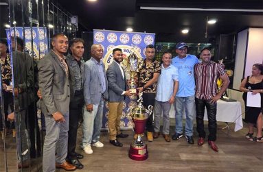 OSCL president, Shiv Persaud (left), hands over one of the winning trophies to Mercenary’s Yadram ‘Lara’ Bhoj