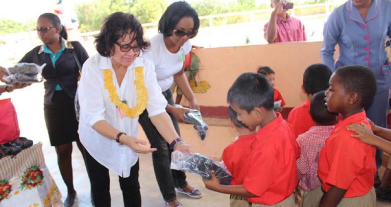 First Lady Sandra Granger assisted in handing out the shoes on Friday (Ministry of the Presidency photo)