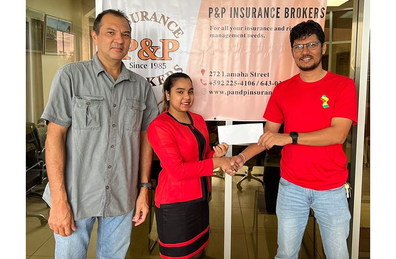 From right, representative of P&P Insurance Brokers and Consultants Ltd., Senior Account Executive Ms Bibi Shanaz Haniff, hands over  sponsorship funds to GSSF Match Director Captain Roul Bhudu, in the presence of GSSF Director Mr Andrew Phang