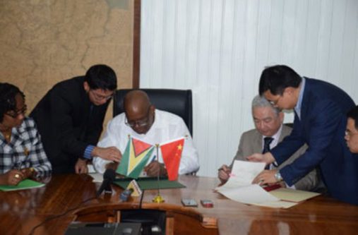 Minister of Finance, Winston Jordan, and outgoing Ambassador of the People’s Republic of China, Zhang Limin sign the Framework Agreement for the East Coast Road expansion project at the Ministry of Finance some two months ago