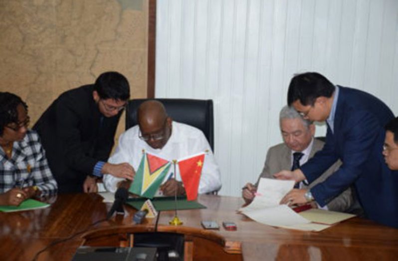 Minister of Finance, Winston Jordan, and outgoing Ambassador of the People’s Republic of China, Zhang Limin sign the Framework Agreement for the East Coast Road expansion project at the Ministry of Finance some two months ago