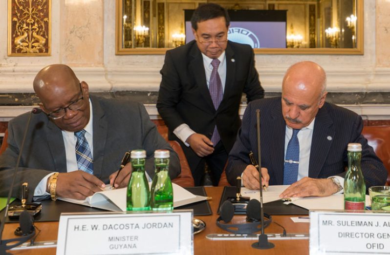 Finance Minister Winston Jordan on Thursday signs the agreement with OFID Director-General Suleiman J. Al-Herbish in Vienna, Austria