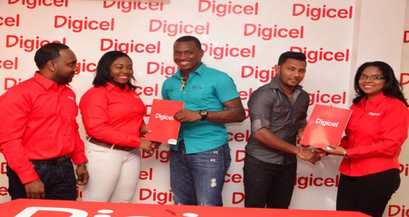 From left to right: Marketing Manager Ramesh Rupchand all smiles as Senior Sponsorship and Events Executive Louanna Abrams hands all-rounder Christopher Barnwell his contract while leg spinner Devendra Bishoo collects from Public Relations Officer Vidya Sanichara. (Adrian Narine photo)