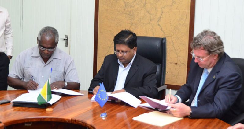Signing the agreement: From left are Public Works Minister Robeson Benn, Finance Minister Dr. Ashni Singh, and EU Delegation Ambassador Mr Robert Kopecky.