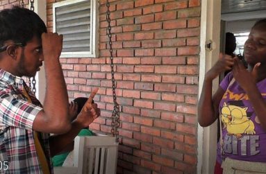 Two youths discussing violence against women in sign language
