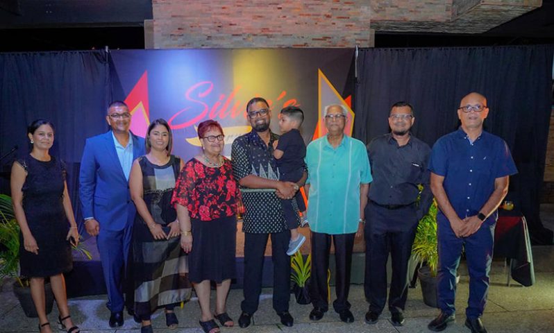 President Dr Irfaan Ali and his son Zayd flanked by founders Rajendra Persaud and his wife Prampattie “Silvie” Persaud and Chief Executive Officer, Bramanand Persaud (second from left) with wife Chief Operations Officer Dr. Shanti Persaud (third from left) with other family members to celebrate the 50th anniversary of Silvie’s Industrial Solutions at Lusignan, ECD (Office of the President photo)