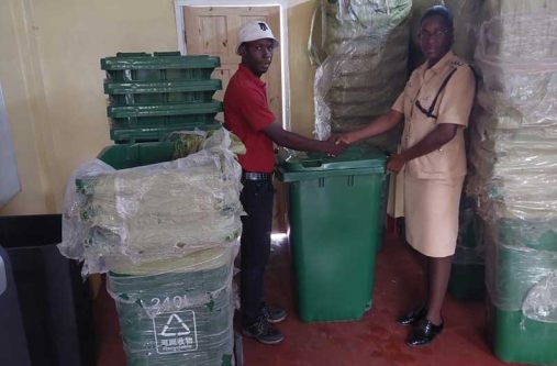 Lawrence King, a representative of Silvie's Industrial Solutions formally hands over the bins to Sergeant Morris