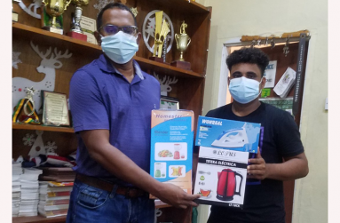 RHTYSC Asst Secretary/CEO Simon Naidu hands over donation to Dr Cecil Beharry, president of Rose Hall Canje Cricket Club.