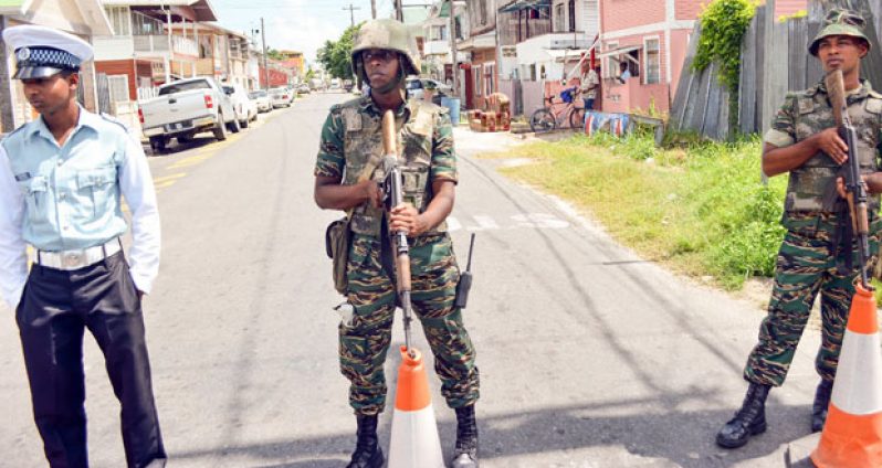 A police officer and two soldiers during the simulation exercise outside the Georgetown Prison on Friday. (Samuel Maughn photo)