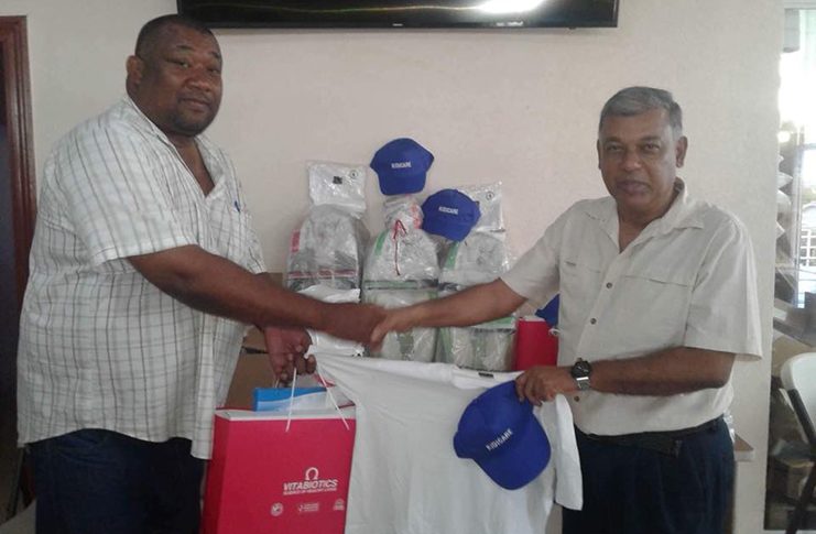 Chief Executive Officer of Mike’s Pharmacy, Lakhram Singh (right) hands over some of the prizes to President of the Berbice Cricket Board, Hilbert Foster, for last Saturday’s final. Singh has renewed the sponsorship for 2019.