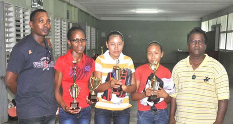 (L-R) Region 9 Athletes Valesa Harding, Mary Leandrew and Simona Lawrence will all be on show this weekend at the region’s CARIFTA Games trials this week. Also in picture is Sugereem Singh (first from right) and chairman Kenrick Lewis.