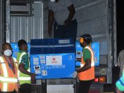 One of the boxes which contains the vaccines being transported from the Caribbean Airlines aircraft to a cold-storage truck on Tuesday evening (Adrian Narine photo)