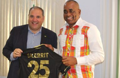Prime Minister Roosevelt Skerrit presents a jersey to FIFA vice-president and CONCACAF president, Victor Montagliani, during his visit to the island of Dominica on Friday