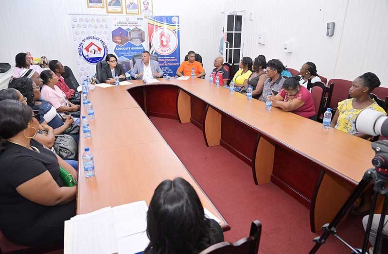 At headtable: Housing and Water Minister,  Collin Croal; Minister within the Ministry, Susan Rodrigues; Permanent Secretary, Mr. Bishram Kuppen, flanked by beneficiaries of the Adequate Housing and Urban Accessibility Programme