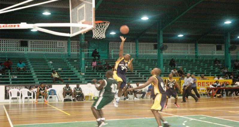 Guardians guard Nikkoloi Smith goes airborne to score over Jets’ Adrian Webster during his team’s 66-56 victory last Sunday at the Cliff Anderson Sports Hall.