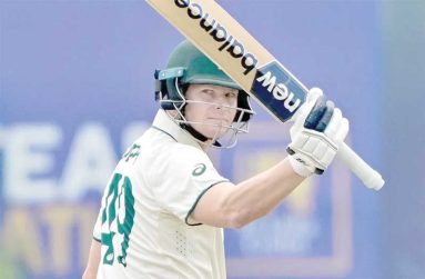 Steven Smith raises his bat after becoming the fourth Australian to reach 10,000 Test runs  •  (AP Photo/Eranga Jayawardena)