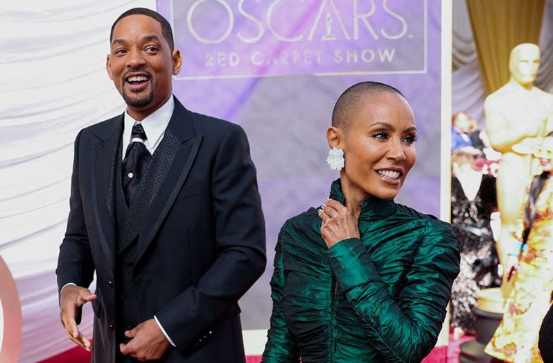 Will Smith and Jada Pinkett Smith pose on the red carpet during the Oscars arrivals at the 94th Academy Awards in Hollywood, Los Angeles, California, U.S., March 27, 2022. REUTERS/Mike Blake