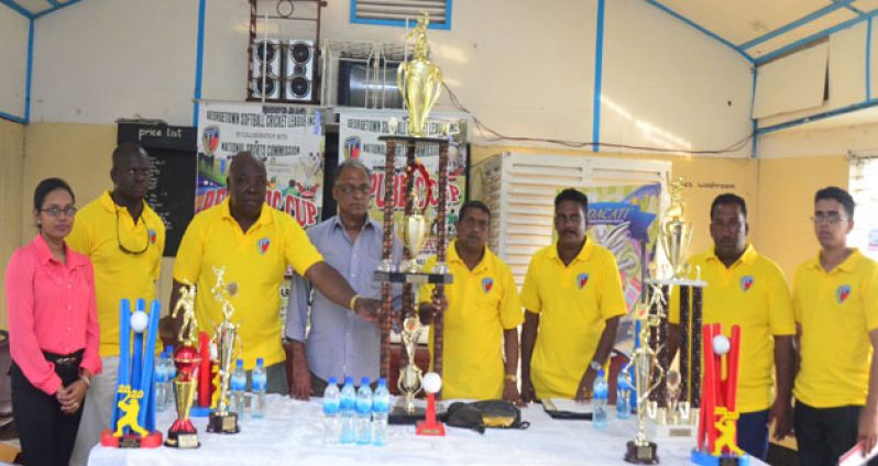 Director of Sport Neil Kumar (4th from left presents the winners trophy to the organisers of the Guyana Softball Cricket League ‘Republic Cup’ T20 Tournament (Adrian Narine photo)