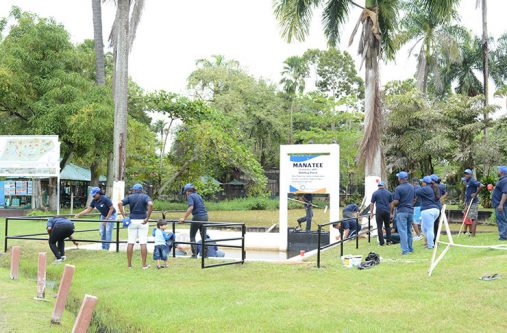 Sol-Guyana The team from Sol Guyana Inc during the maintenance exercise at the manatee pond in the Botanical Gardens