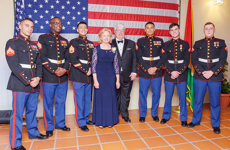 Ambassador Lynch and her husband, Dr. Kevin Healey with members of the Marine Corps at the anniversary celebration on Saturday