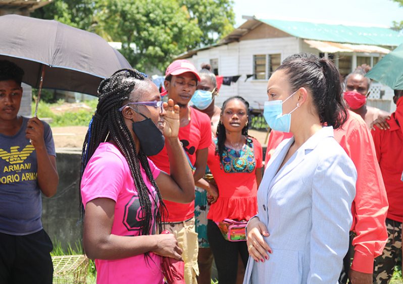 Minister within the Ministry of Housing and Water, Susan Rodrigues, interacting with one of the many residents of Sophia during her visit.