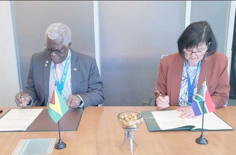 Lt. Col. (Ret’d) Egbert Field, Director General of the Guyana Civil Aviation Authority (left) and Barbara Creecy, Minister of Transport of South Africa (right) sign the agreement