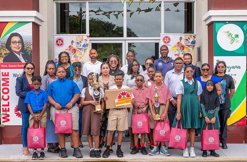 Executive Director of GNBS, Trevor Bassoo, flanked by finalists of the competition, teachers, parents and representatives from GNBS