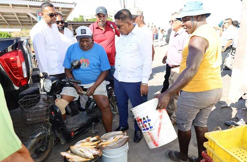 Minister of Agriculture, Zulfikar Mustapha, speaks to a fisherman at the D’Edward Three-Door koker in Region Five