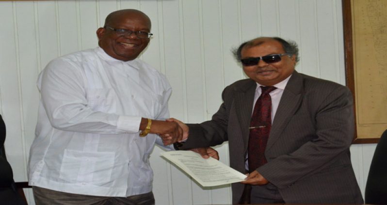 Minister of Finance, Winston Jordan and Fedders Lloyd representative Ajay Jha shake hands following the signing of the MOU (Photos courtesy of the Ministry of Finance)
