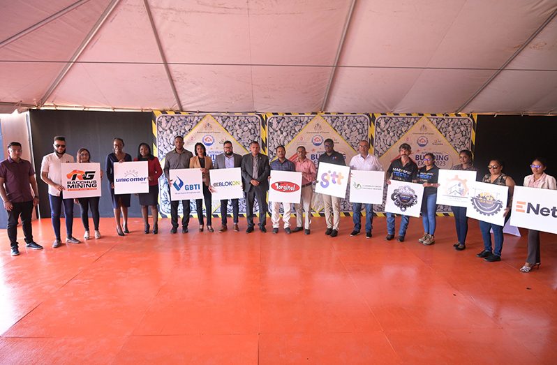 Minister of Housing and Water Collin Croal (Centre) and some of the corporate sponsors of Building Expo 2023