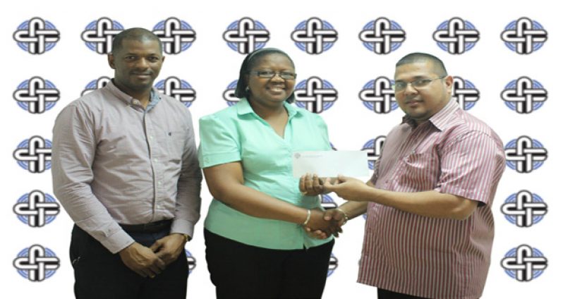 Avalon Jagnandan, Marketing and Sales Manager for Continental Group of Companies, hands over sponsorship cheque to Ms Deirdre Edghill in the presence of Godfrey Munroe, president of the GTTA.