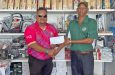 Ganesh Persaud (right) hands over the sponsorship cheque to Tournament Director John Ramsingh.