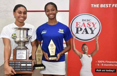 The Wiltshire sisters, Akeila (left) and Larissa, display their trophies after dominating the BCIC All Jamaica Senior Squash Championships in Kingston last weekend. (Newsroom/Ravin Singh photo)