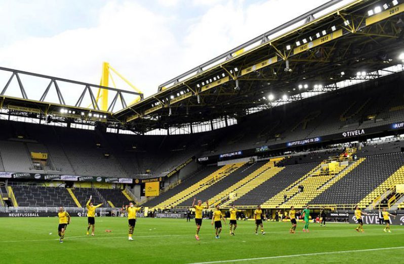 Dortmund players celebrate after the match in Germany, as play resumes behind closed doors following the outbreak of the coronavirus disease (COVID-19). (Martin Meissner/Pool via REUTERS)