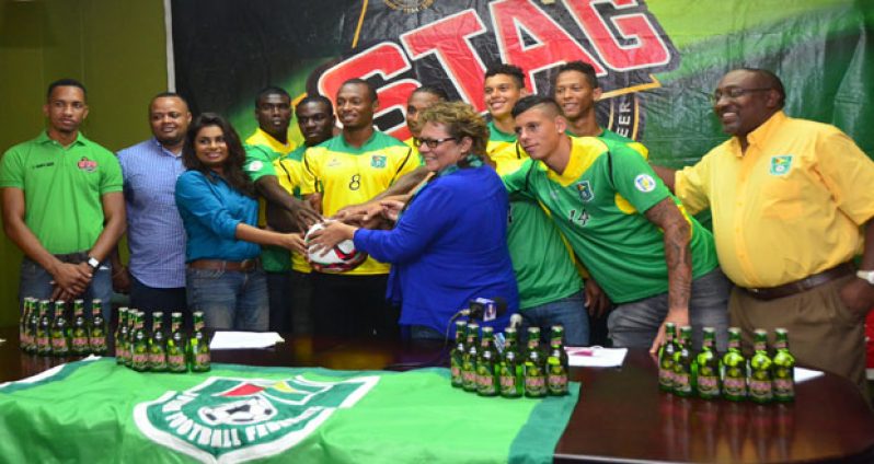 All hands on deck! Ansa McAl’s staff and members of the Golden Jaguars after the signing yesterday. (Adrian Narine photo)