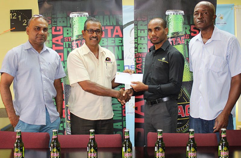 Stag Beer Brand Manager, Lindon Henry, presents the sponsorship to GFSCA’s Vice-president, Jailall Deodass, while officials of the GFSCA, Ricky Deonarain and Wayne Jones look on.