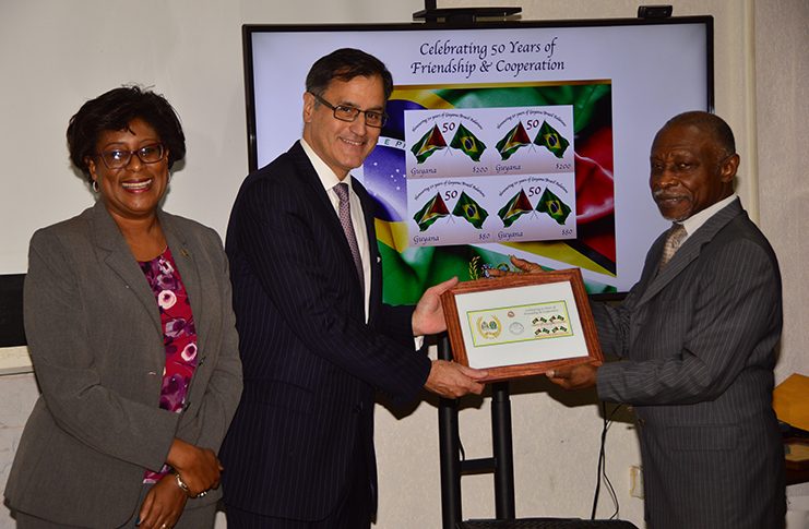 Minister of Foreign Affairs, Mr. Carl Greenidge (right) and Embassy of Brazil Deputy Head of Mission, Mr. Paul Silos with replicas of the stamp. To their left is Minister of Public Telecommunication, Ms. Cathy Hughes (Photo by Adrian Narine)